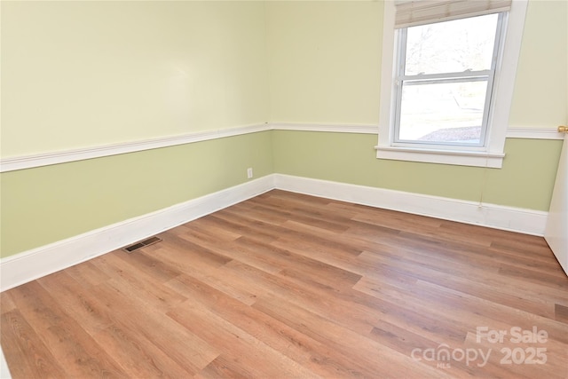 unfurnished room with hardwood / wood-style floors