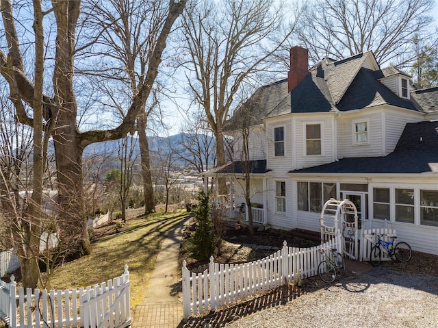 view of front of property with a mountain view and a sunroom