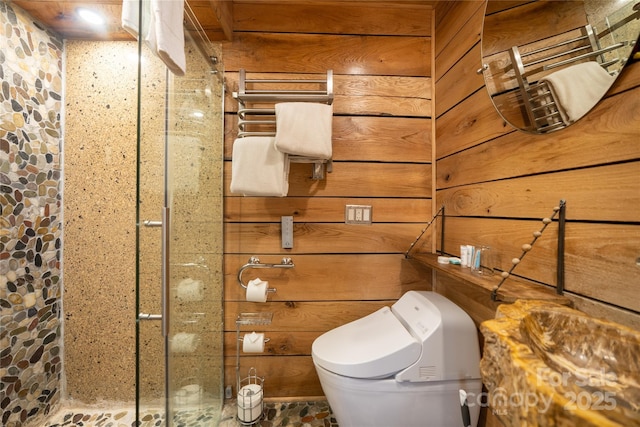 bathroom featuring wood walls and toilet