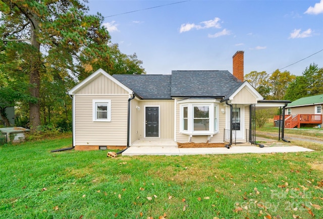 back of house with a lawn