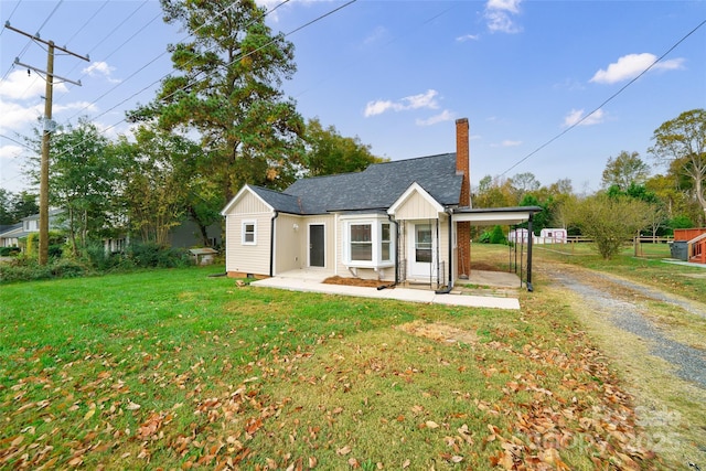 back of house with a lawn