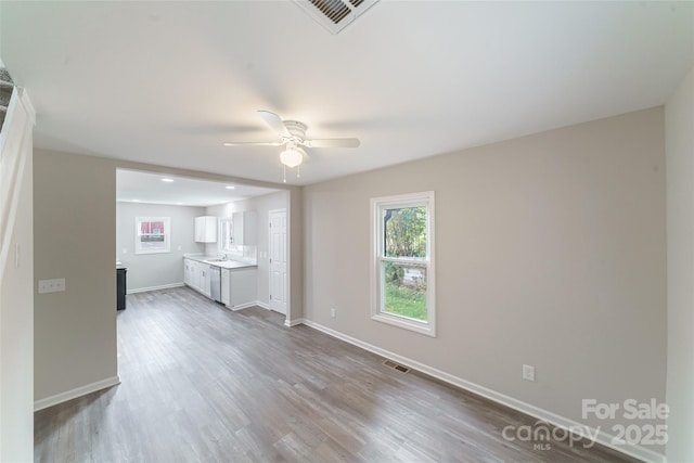 unfurnished living room with hardwood / wood-style flooring and ceiling fan