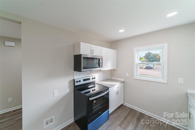 kitchen featuring white cabinetry, electric range, tasteful backsplash, and dark hardwood / wood-style floors