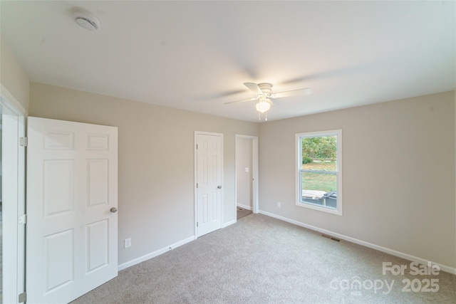 unfurnished bedroom featuring carpet and ceiling fan