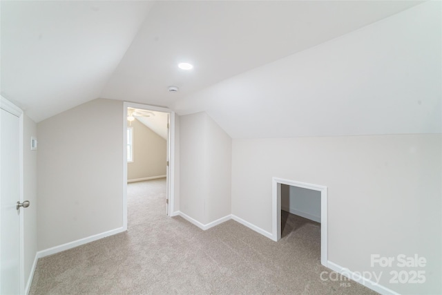 bonus room featuring light colored carpet and vaulted ceiling