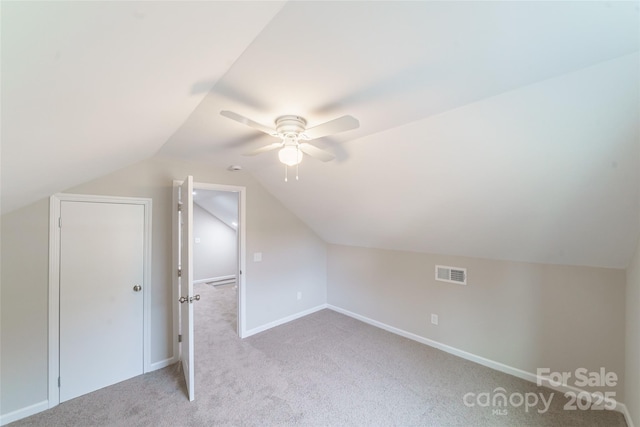 additional living space featuring ceiling fan, light carpet, and vaulted ceiling