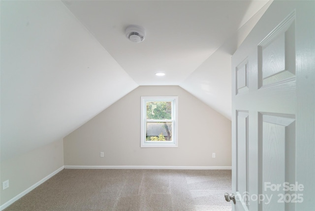 bonus room with carpet flooring and lofted ceiling