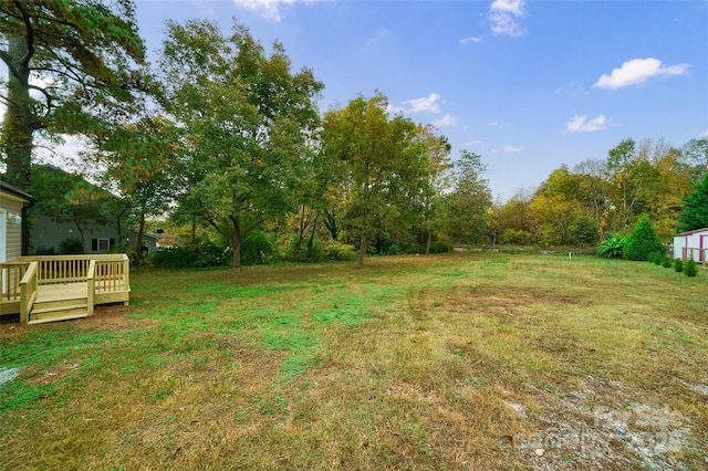 view of yard featuring a wooden deck