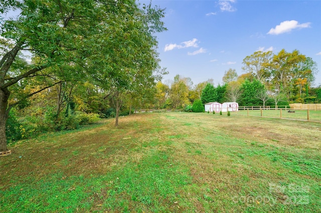 view of yard with a rural view