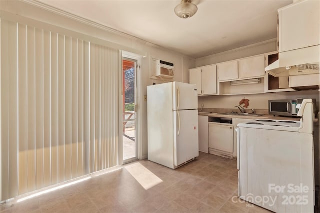 kitchen featuring stove, a wall unit AC, sink, white refrigerator, and white cabinets