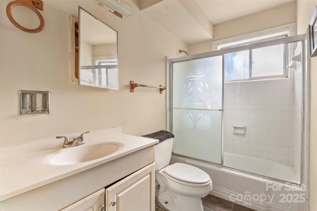 full bathroom with tile patterned flooring, vanity, toilet, and bath / shower combo with glass door