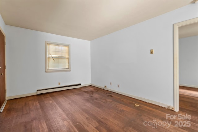 spare room with hardwood / wood-style floors and a baseboard radiator