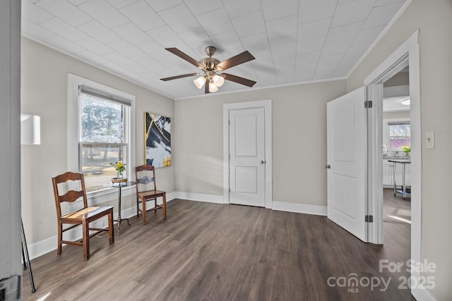 sitting room with ceiling fan, dark hardwood / wood-style floors, and crown molding