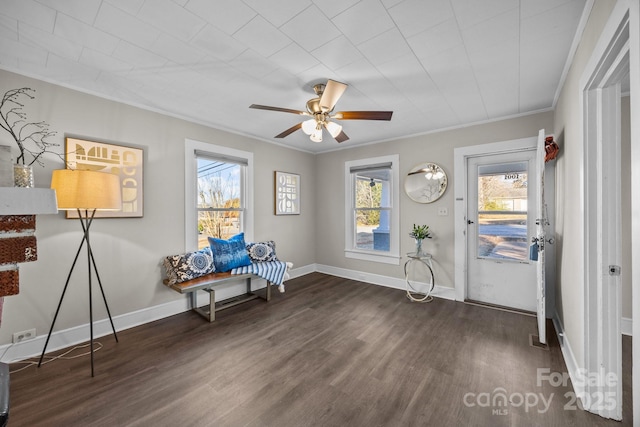 sitting room with ceiling fan, dark hardwood / wood-style floors, and ornamental molding