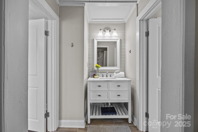 bathroom featuring hardwood / wood-style floors, vanity, and crown molding