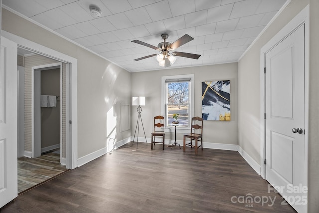 unfurnished room with ceiling fan, dark hardwood / wood-style flooring, and crown molding