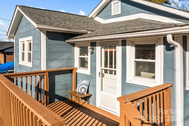 view of exterior entry featuring a wooden deck