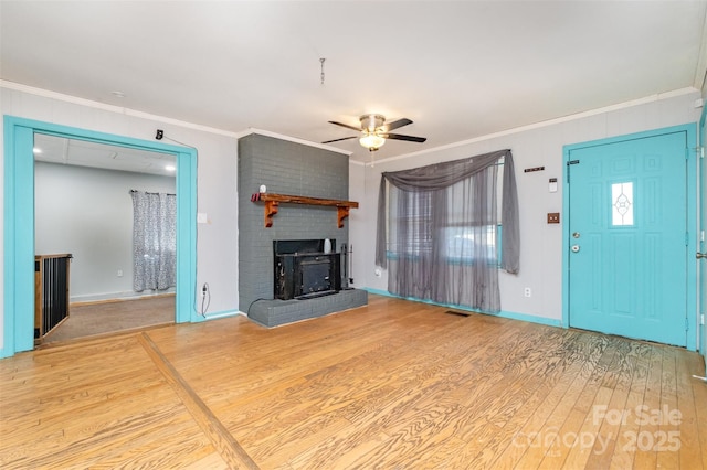 unfurnished living room with ceiling fan, wood-type flooring, and ornamental molding