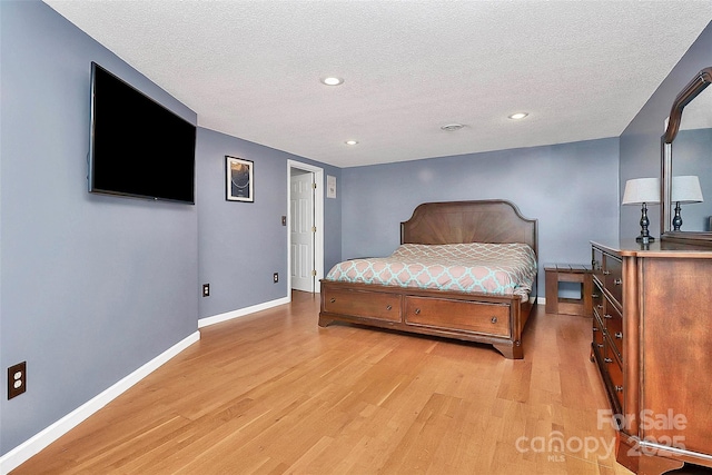 bedroom featuring a textured ceiling and light wood-type flooring