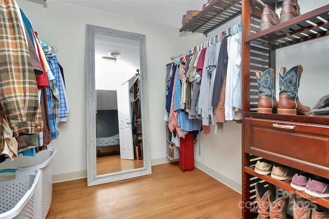 walk in closet featuring light hardwood / wood-style flooring