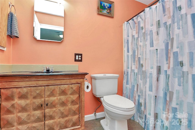 bathroom featuring vanity, toilet, and curtained shower