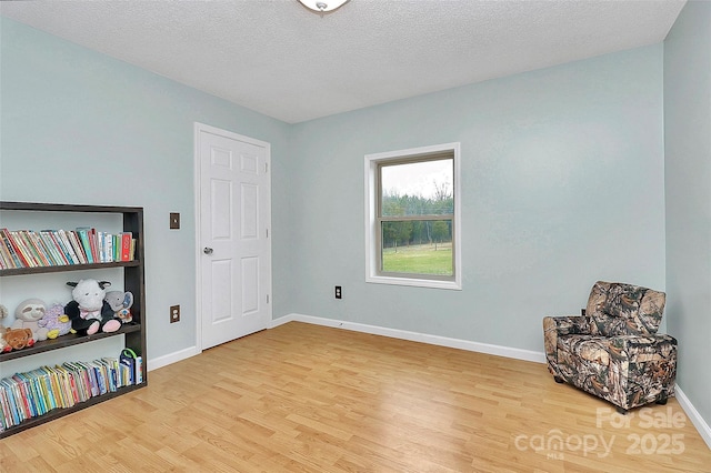 sitting room featuring hardwood / wood-style floors and a textured ceiling