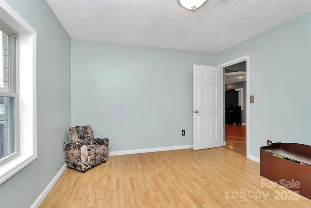 interior space featuring light hardwood / wood-style floors and a textured ceiling