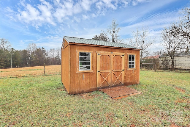 view of outbuilding with a lawn