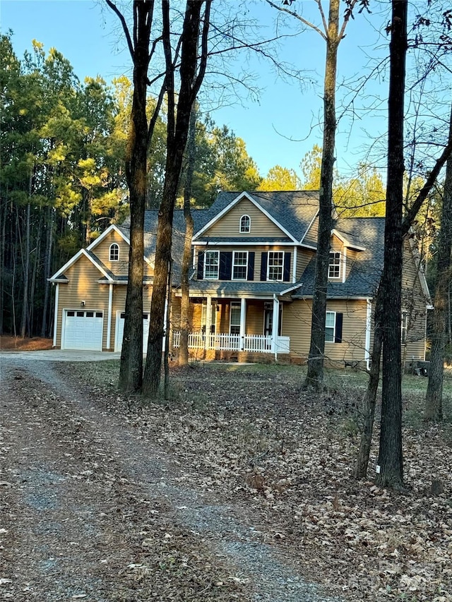 view of front of house with covered porch and a garage