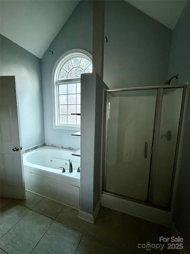 bathroom with tile patterned flooring, lofted ceiling, and independent shower and bath