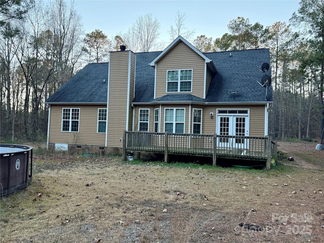 rear view of house with central air condition unit and a wooden deck