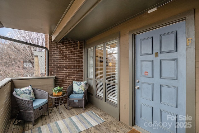 421 N Church St Unit 12F, Charlotte, NC 28202 - view of exterior entry with brick siding and a balcony