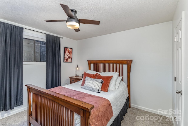 carpeted bedroom with a ceiling fan and a textured ceiling