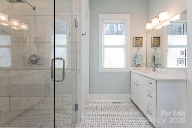 bathroom featuring vanity and a shower with door