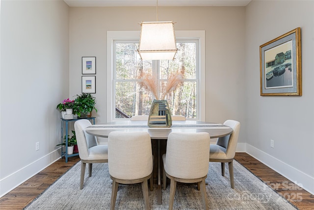 dining space with wood-type flooring