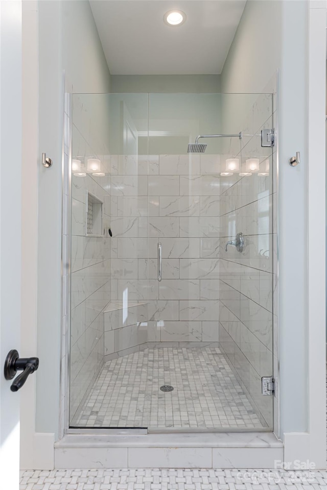 bathroom with a shower with shower door