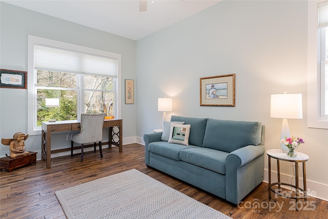 living room with ceiling fan and dark hardwood / wood-style flooring