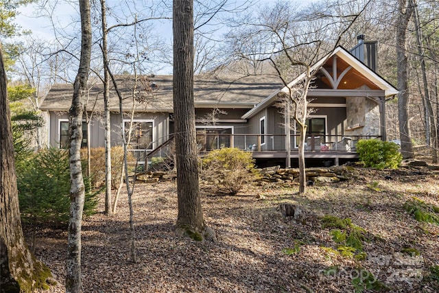 back of house with a wooden deck