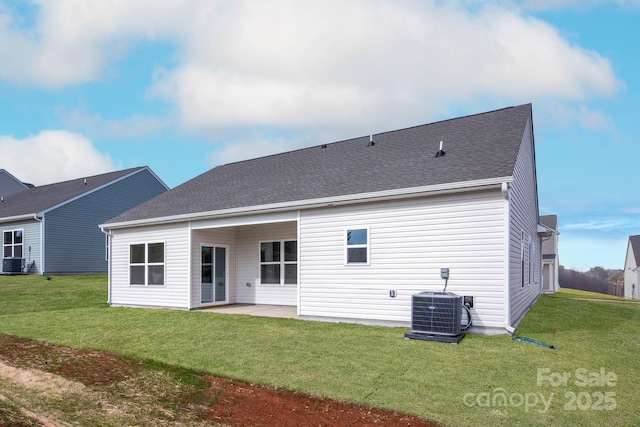 rear view of property featuring a yard, a patio, and central AC unit