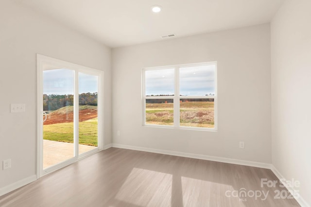 empty room with light hardwood / wood-style flooring