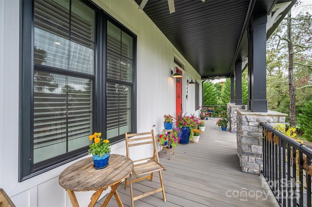 wooden terrace with ceiling fan and a porch