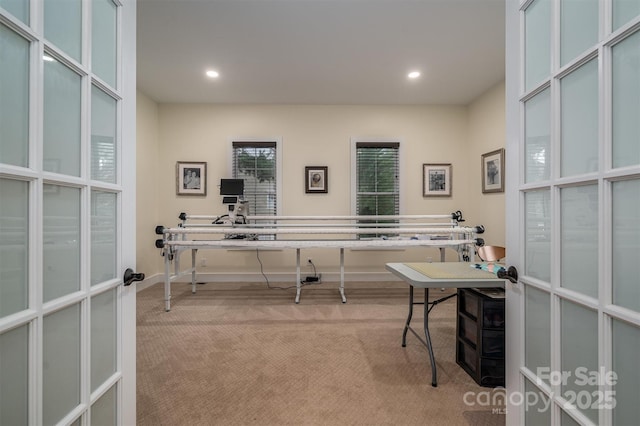 home office with french doors and light colored carpet