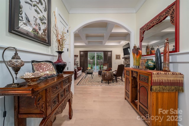 corridor featuring coffered ceiling, beam ceiling, crown molding, and light hardwood / wood-style flooring