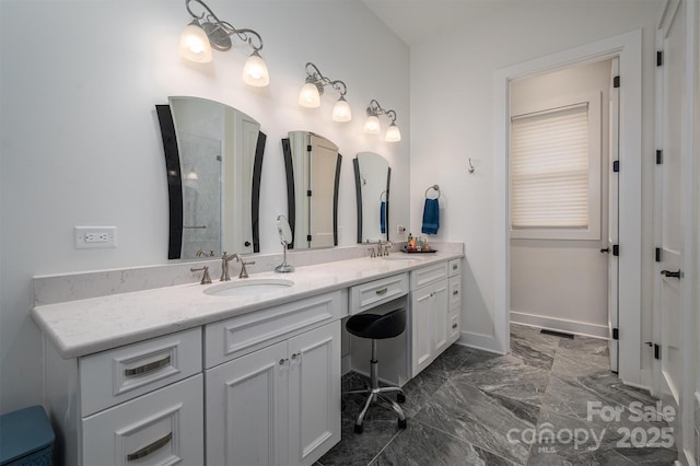 bathroom with a shower and vanity