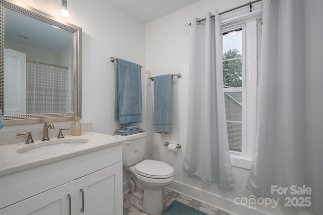 bathroom with tile patterned floors, a shower with curtain, vanity, and toilet