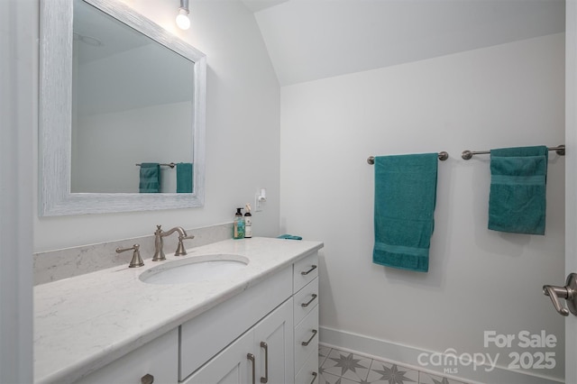 bathroom featuring vanity and vaulted ceiling