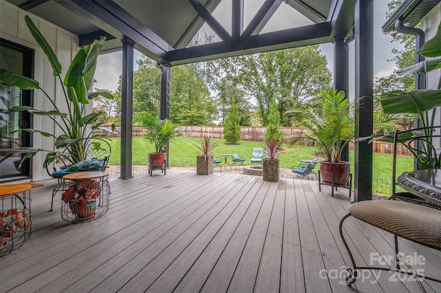 wooden terrace featuring a yard