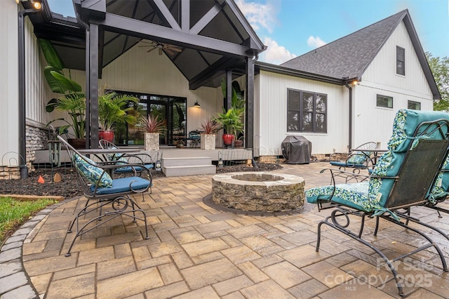 view of patio / terrace featuring ceiling fan and an outdoor fire pit