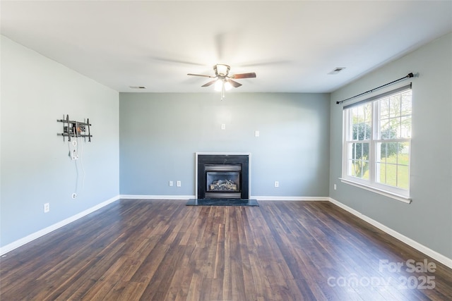 unfurnished living room with ceiling fan and dark hardwood / wood-style floors