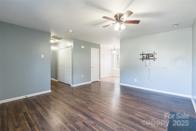 spare room featuring ceiling fan and dark hardwood / wood-style flooring